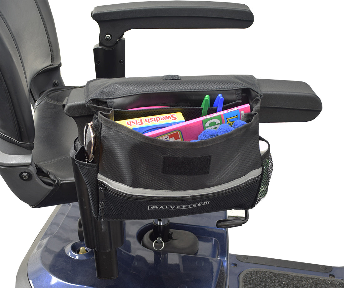 Saddle Bag, Seat Back Bag (Backpack), & Cup Holder Combination for Mobility Scooters, Power Chairs, & Wheelchairs, showing a black bag filled with stationery placed on a chair.