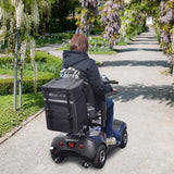 Extra Large Insulated Seat Back Bag (Backpack) for Mobility Scooters & Power Chairs on a person's back while riding a scooter, highlighting its spaciousness and secure storage for various items.