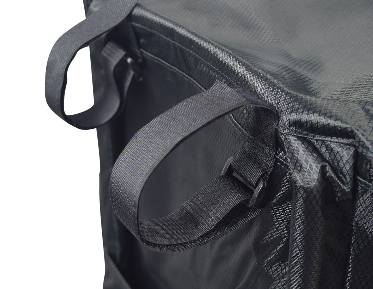 Soft Basket Tiller Bag for Mobility Scooters: Close-up of a black bag with straps, zippered lid, and mesh pockets, made of weather-resistant nylon with a reflective safety strip.