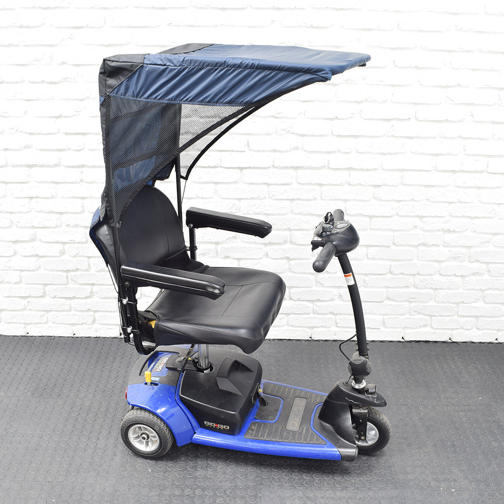 Weatherbreaker Canopy for Scooters & Power Chairs, featuring a protective canopy mounted on a blue and black scooter, designed to shield users from sun and rain.