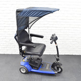 Weatherbreaker Canopy for Scooters & Power Chairs featuring a protective canopy mounted on a blue and black scooter, designed to shield users from sun and rain while enhancing mobility.