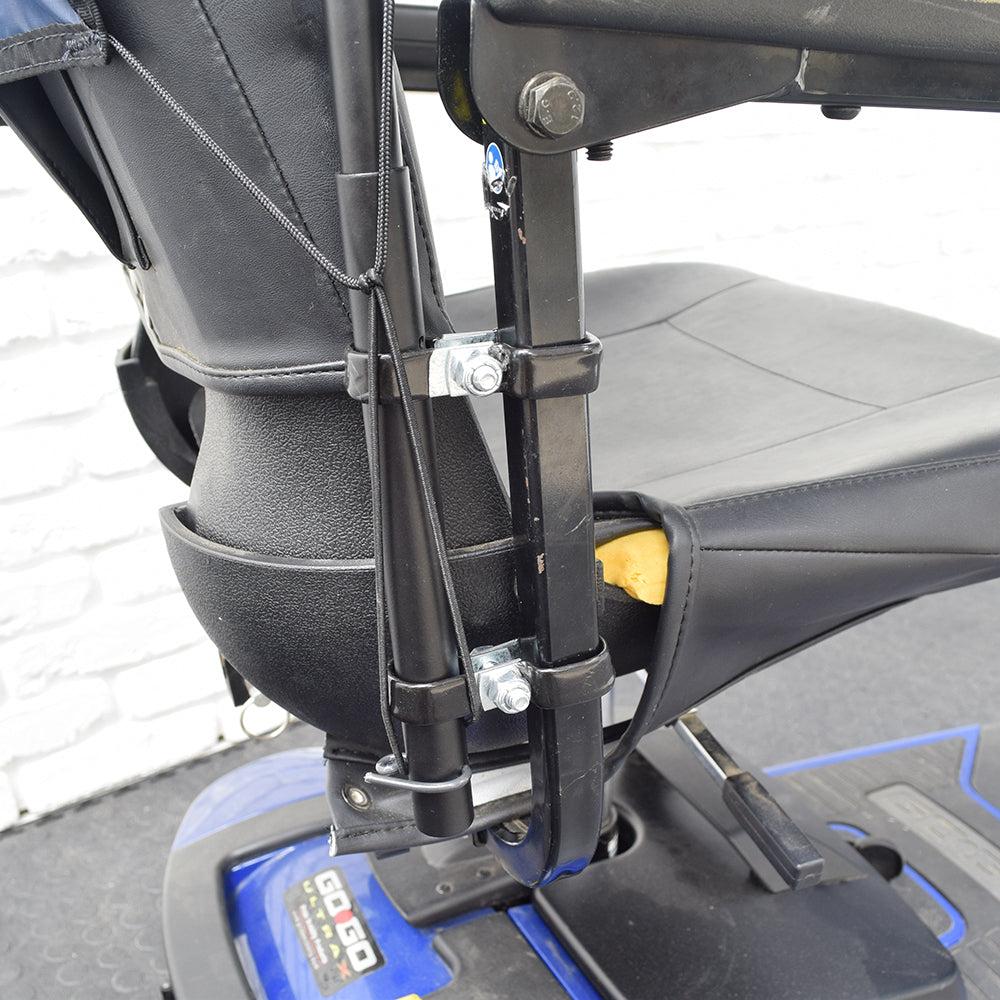 Weatherbreaker Canopy for Scooters & Power Chairs: A close-up of the canopy mounted on a blue and black scooter, showcasing the durable frame and mounting brackets for weather protection.