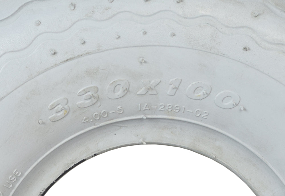 Close-up of the 4.00-5 (13x4, 330x100) Pneumatic Front Tire for Shoprider Sprinter XL3 & XL4 Deluxe Scooters, featuring a zigzag tread pattern for optimal traction and rollability.