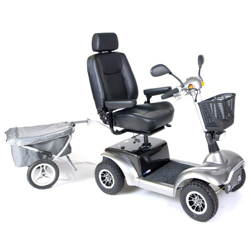 Trailer for Mobility Scooters: A close-up of a scooter with an attached aluminum and fabric trailer, featuring a basket for transporting large or bulky items.