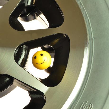 Mister Smiley ABS Valve Stem Cap Cover: A yellow smiley face cap designed for bike and scooter Schrader valves, adding a cheerful touch to your wheels.