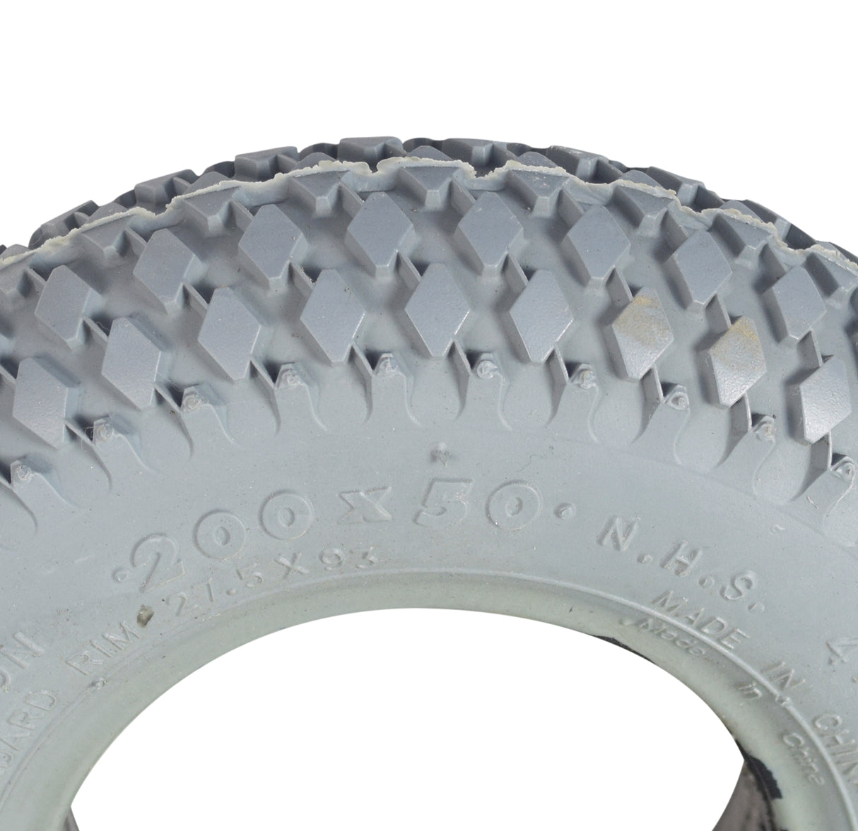 Close-up of the Primo 8x2 (200x50) foam-filled mobility tire with C968G Rebel knobby tread, showcasing the durable tread pattern designed to prevent flats. Ready to install.