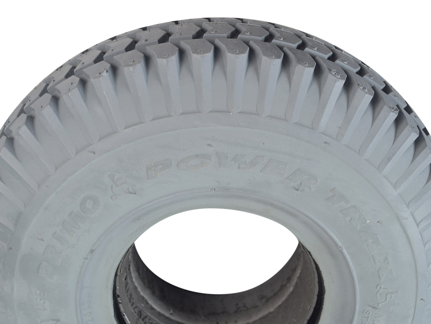 Close-up of a 3.00-4 (10x3, 260x85) Foam-Filled Gray Tire for the ActiveCare Pilot (2310/2410) Scooters & ActiveCare Power Chairs, featuring non-marking gray rubber and detailed tread patterns.