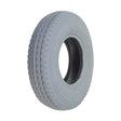 2.80/2.50-4 (9x3) Pneumatic Mobility Tire with C178G Power Edge Sawtooth Tread featuring a close-up of the non-marking gray rubber tire, highlighting its detailed tread pattern and central hole.