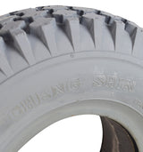 Close-up of a 12x4 (4.10/3.50-5) Foam-Filled Mobility Tire with C156 Knobby Tread, showcasing detailed knobby tread and solid construction for indoor and outdoor use.