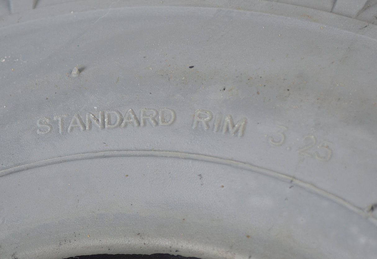 Close-up of a 12x4 (4.10/3.50-5) Foam-Filled Mobility Tire with C156 Knobby Tread, showing detailed tread pattern and sturdy construction for flat-free dependability.