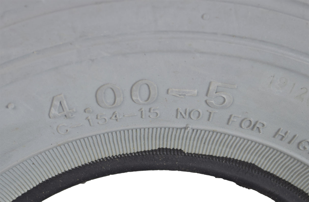 Close-up of a 4.00-5 (13x4, 330x100) Foam-Filled Mobility Tire with C154 Diamond Tread, showcasing detailed treads and solid, non-marking gray rubber for mobility scooters and power chairs.