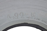 Close-up of a 4.00-5 (13x4, 330x100) Foam-Filled Mobility Tire with C154 Diamond Tread, showcasing detailed treads and solid, non-marking gray rubber for mobility scooters and power chairs.