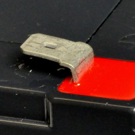 24 Volt Battery Pack for the Radio Flyer Ultimate Go-Kart (940) showing a close-up of a metal buckle on a black and red surface, part of the battery pack's secure design.