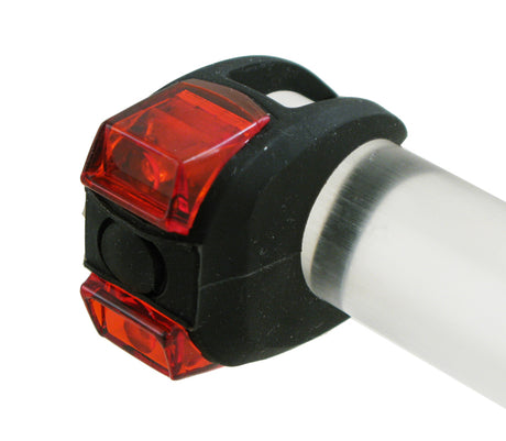 Close-up of the TL-L220 OmniGrip Taillight, a compact safety accessory for bikes or scooters, designed to enhance visibility in low-light conditions.