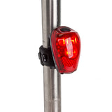 Close-up of the TL-L302 USB Taillight attached to a metal pole, highlighting its design and functionality for enhanced rear visibility on bicycles and scooters.