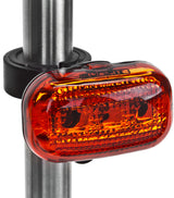 Close-up of the TL-L340 LED Taillight, showcasing the cylindrical metal casing with a bright red light, designed for enhanced visibility and safety on bicycles and scooters.