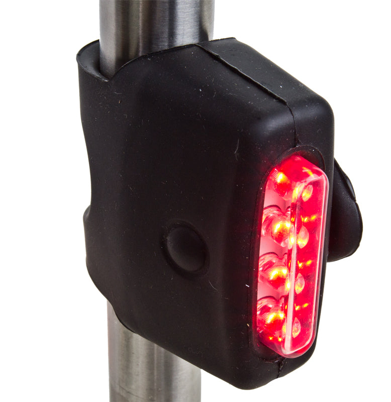 Close-up of the TL-L401 Griplite Taillight, a compact, safety-focused rear light designed for bicycles and scooters, emphasizing its red illumination for enhanced visibility in low-light conditions.