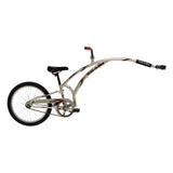 Trail-A-Bike Original Folder One Trailer Bike with long handlebar, black seat, and full chain guard, designed for introducing children to cycling. Features a folding frame, steel hitch, and safety flag.