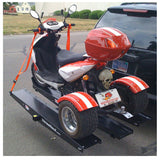 Carrier with Ramp for Trike Scooters shown mounted on a trailer, featuring a sturdy build with multiple tie-down loops, anti-tilt lock bracket, and reversible rails designed for three-wheel motor scooters.