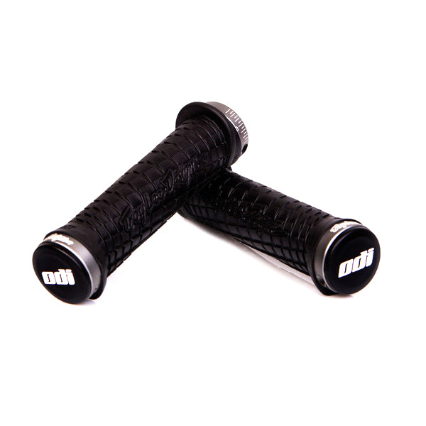 Troy Lee ODI Lock-on Handlebar Grips for Bikes & Scooters, featuring close-up view of black handlebars with custom flanged design and grooved channels for optimal grip.