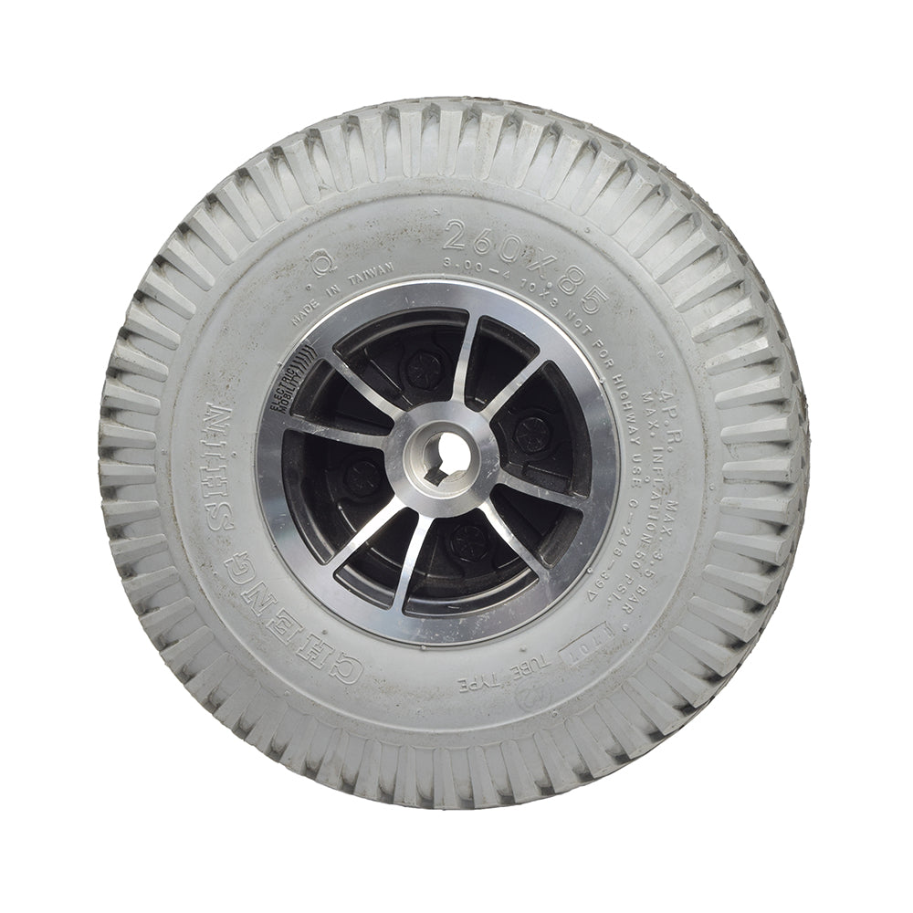 Foam-Filled Drive Wheel Assembly for Rascal 312 (Used) featuring a knobby tread tire, centered hubcap, and split-rim design. The wheel shows minimal wear with a few tread stains.