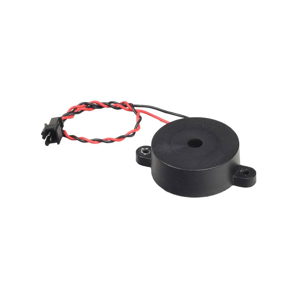 Horn Module for the CTM HS-320 (Used) showing a black round object with red and black wires attached, essential for ensuring your scooter's horn functions properly.