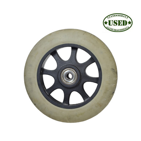 Anti-Tip Front Wheel for the Jazzy 1107, Select, & Select GT (Used) featuring a white tire and black rim, showing signs of wear. Ideal for enhancing stability in power chairs.