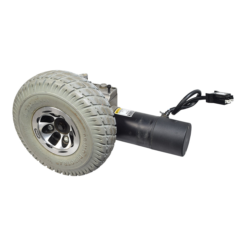 Left Side Motor & Wheel Assembly for the Invacare Pronto M71 (Used) showing a close-up of the wheel with a black foam-filled tire and a visible motor component.