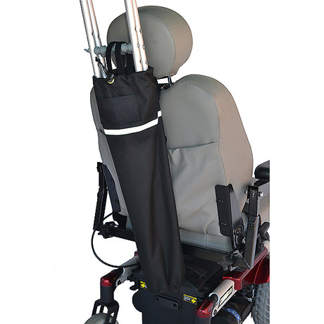 Close-up of a wheelchair with a Universal Crutch Holder attached to the seatback, showcasing its secure hook and loop strap and durable, water-resistant polyester material.