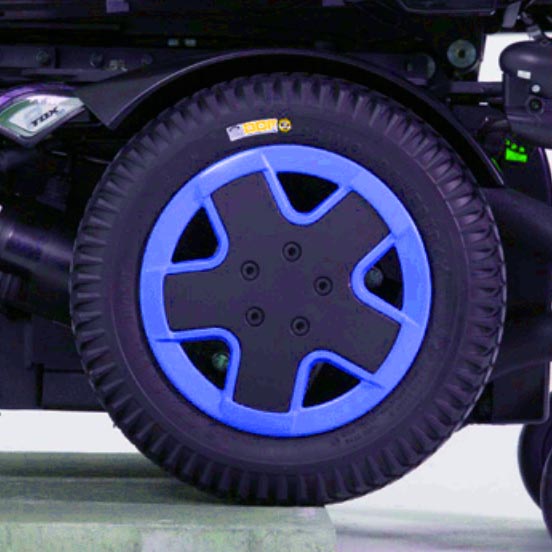 Blue Drive Wheel Rim Insert for the Invacare TDX SP2 Power Chair, featuring a close-up of a 9-inch rim insert accentuating the dark gray/black hub of the power chair's drive wheel.