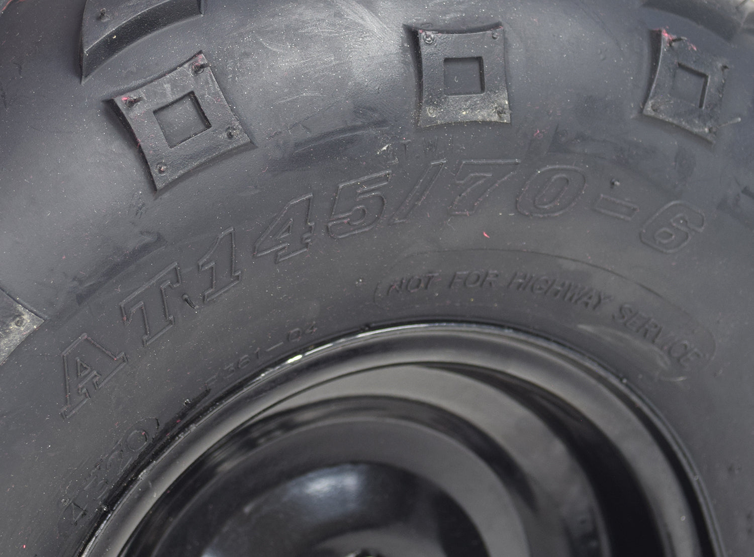 Front Left Wheel Assembly with Rim & Tire for Coleman KT196 & CK196 196cc 6.5 Hp Go-Karts, featuring a 145/70-6 steel rim and V-tread tire for enhanced traction, shown in close-up.