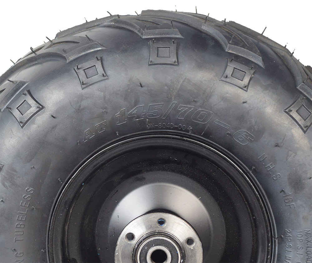 Close-up of the Rear Wheel Assembly for the TaoTao DB100 105cc Mini Bike, showcasing the V-tread tire, rim, and wheel bearings designed for optimal control on rough surfaces.