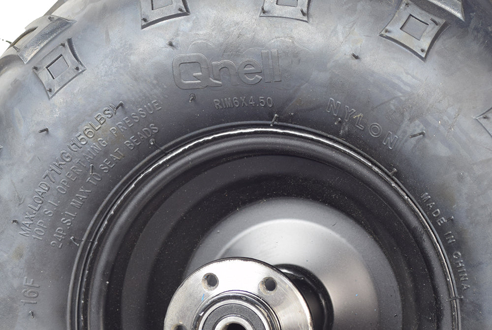 Close-up of the 145/70-6 Rear Wheel Assembly for the Coleman RB100 105cc Mini Bike, showcasing the robust V-tread tire, wheel bearings, and rim designed for optimal control on rough terrains.