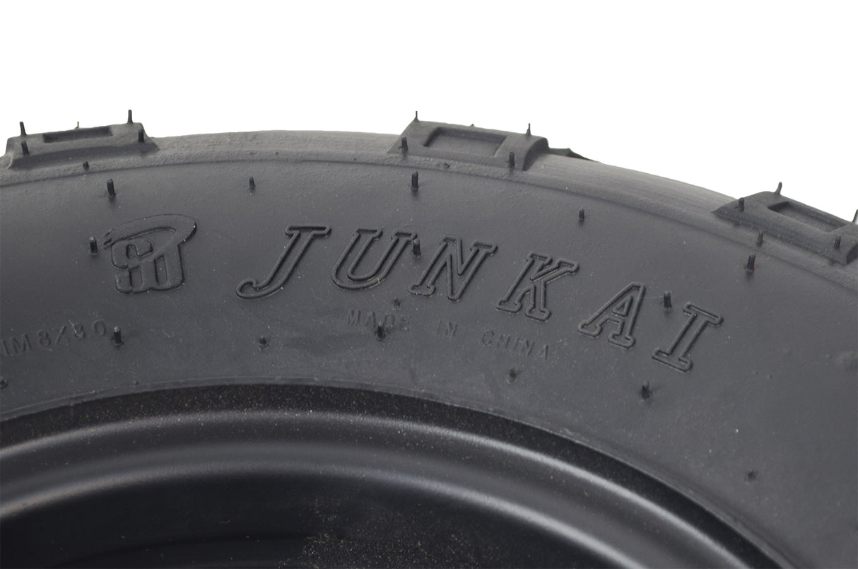 Close-up of the Front Wheel Assembly with Tire for the Baja MB200 Mini Bike, featuring an aggressive V-tread tire, rim, and hardware components for optimal traction and control on the track.