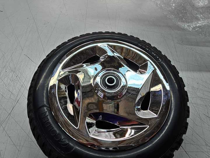 Front Wheel Assembly for the Golden Technologies Buzzaround XL (GB116) & Buzzaround Lite (GB106) (Blemished) featuring a tire with a shiny rim and detailed tread pattern.