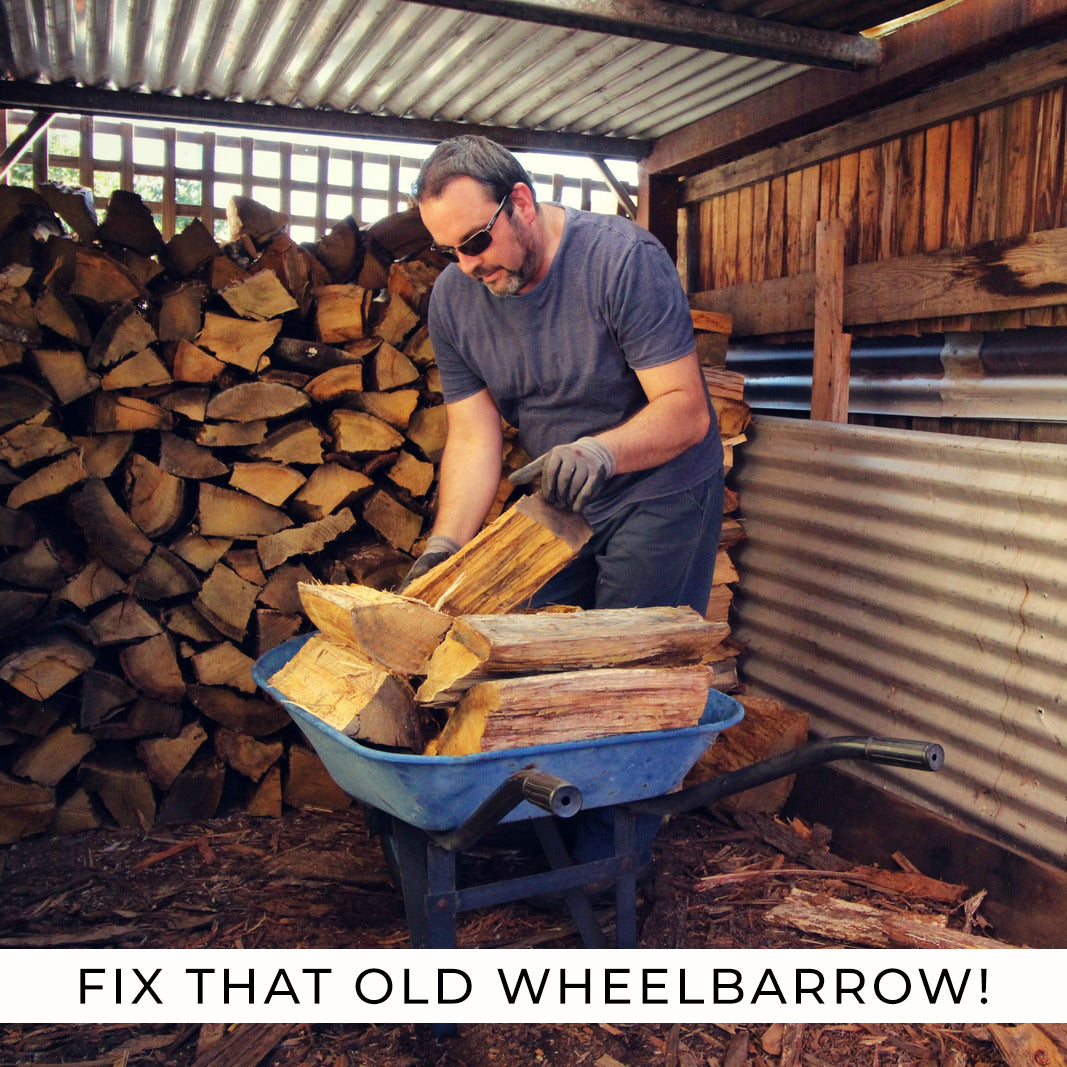 Man pushing a wheelbarrow full of wood, highlighting the 3.00-4 (10x3) Mobility Tire and Inner Tube Set with Knobby Tread designed for mobility scooters and power chairs.