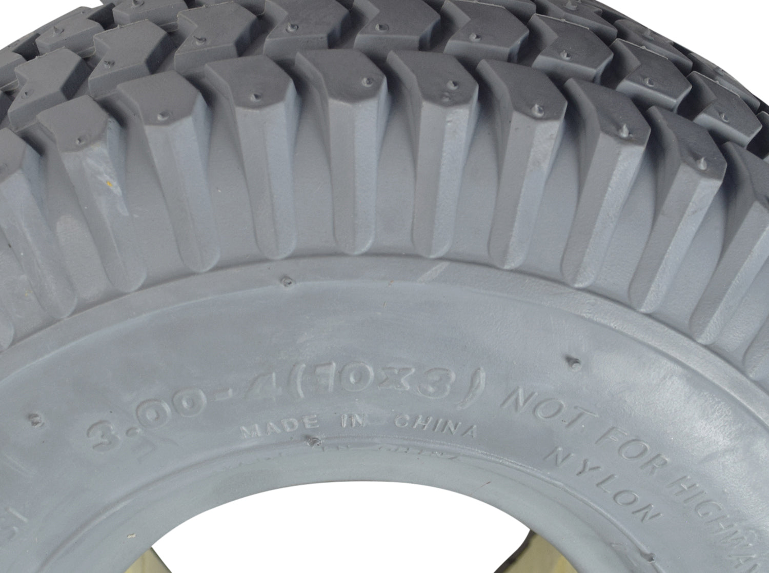 Close-up of a 3.00-4 (10x3, 260X85) Foam-Filled Mobility Tire with C248 Powertrax Tread, showcasing its knobby tread pattern and solid, flat-free design, ideal for mobility scooters and power chairs.