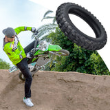 A man on a dirt bike demonstrates the 2.50-10 Tire for the Razor SX500 McGrath Dirt Rocket, showcasing its rugged tread and durability during an outdoor ride.