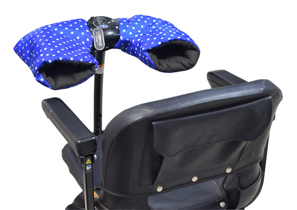 Waterproof Hand Mitts for Scooters, ATVs, & Bikes attached to handlebar, resembling cowls. A polka dot pillow is visible on a nearby chair, indicating indoor setup.