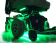 Close-up of a wheel on a Jazzy Power Chair, highlighting the Multi-Color LED Light Kit attachment for enhanced visibility and style.