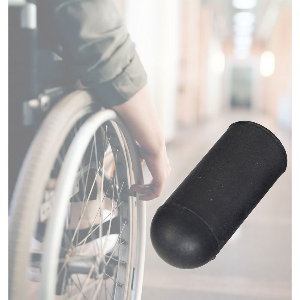 Black Rubber Tips for 5/8 Flat Invacare Style Wheelchair Wheel Locks (Set of 2) shown on a wheelchair wheel lock, highlighting the hand gripping the brake lever with the rubber tip attached.