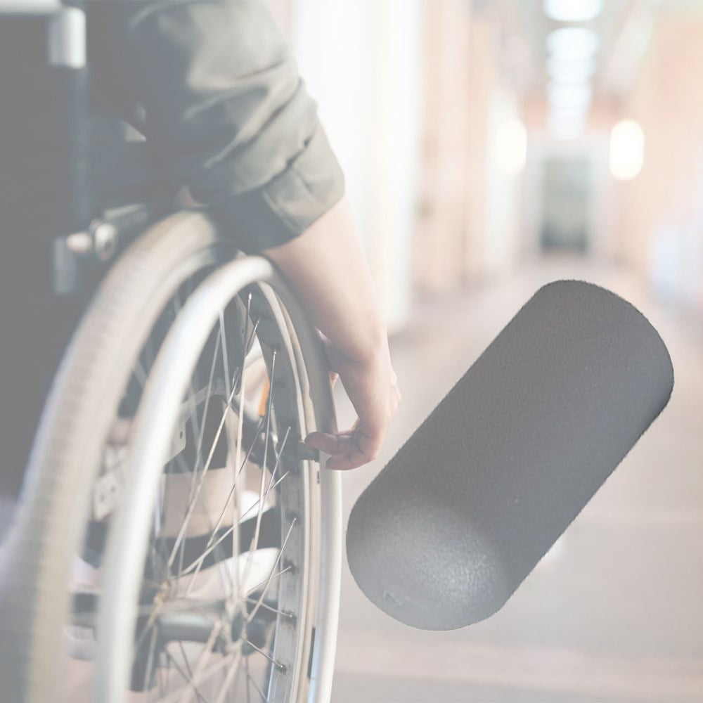 Gray Rubber Tips for 5/8 Flat Invacare Style Wheelchair Wheel Locks (Set of 2) shown on a person's wheelchair, highlighting the gray rubber lever knobs used for gripping the wheel lock mechanism.