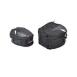 Pair of black Tail Bags for Electric Bikes, featuring webbing straps, pinch-buckles, and zippers. One bag is expandable with a shoulder strap, and the other includes comfort straps for backpack use.