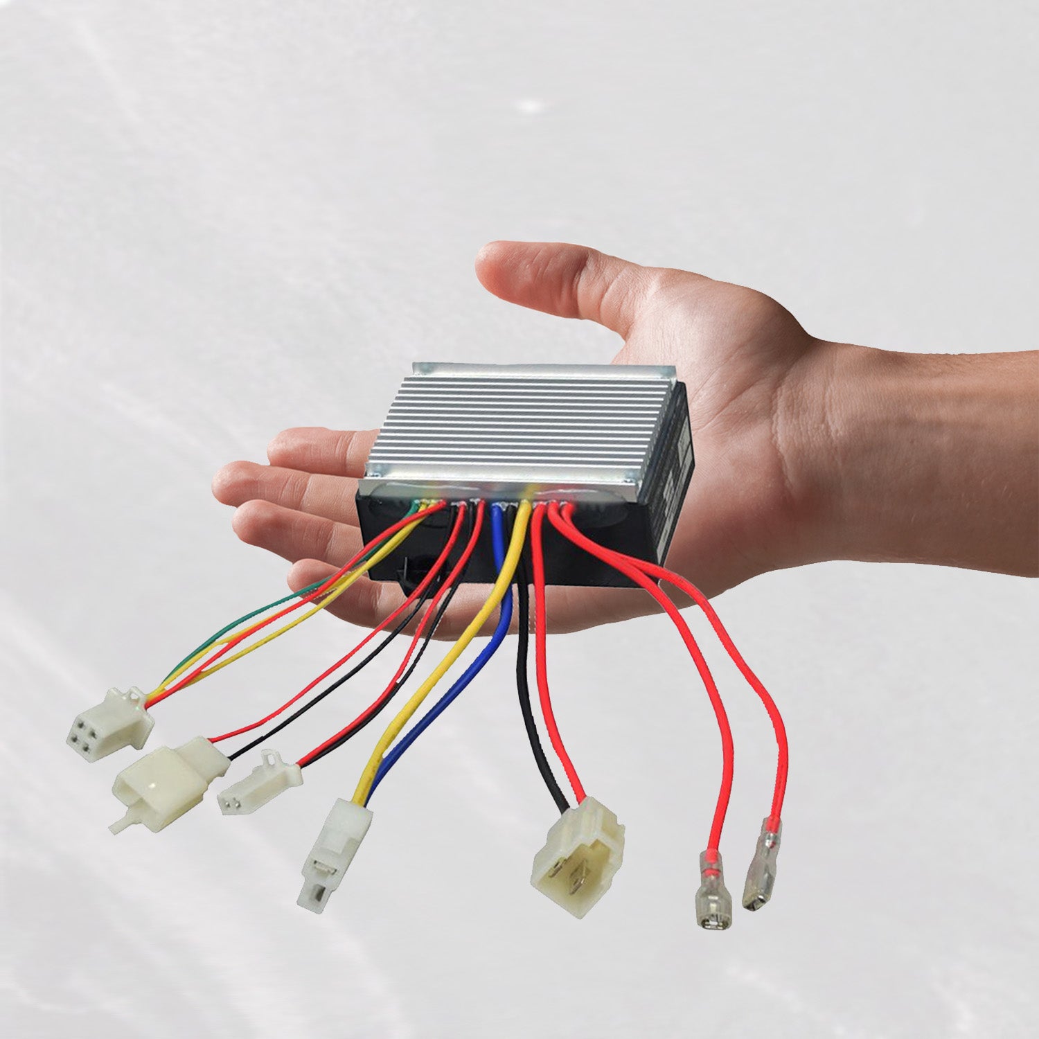 Hand holding ZK2430HB-FS Throttle & Control Module Bundle for Razor E300, Versions 11 and 13-19, showing wires and connectors for scooter compatibility.